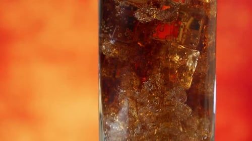 Cola with Ice Cubes Rotate Close-up