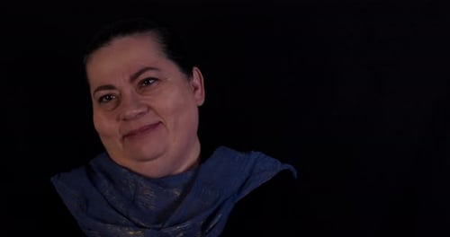 Smiling Woman Headshot Against Black Background