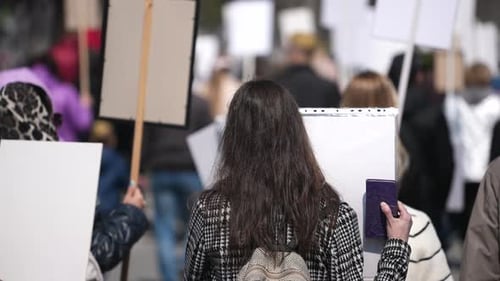 Crowd of People Holding Signs in Urban Protest