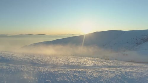 Mist Floating Above Mountain Hills Covered in Fresh Snow, Sunset Panoramic View