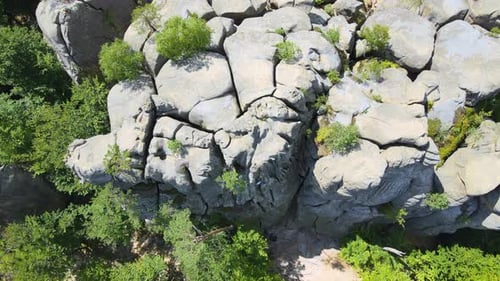 Determined Boy Climber Clambering Up Steep Wall of Rocky Mountain
