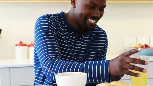 Man using a digital tablet while having juice