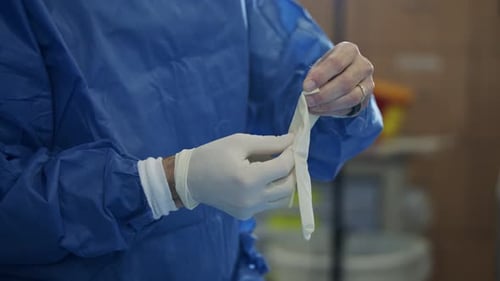 Surgeon Puts on Sterile Gloves Before Surgery