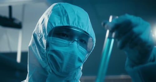 Scientist Examining Sample in Laboratory