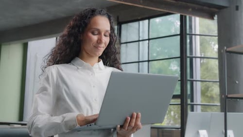 Successful Businesswoman Working in Modern Office Typing on Laptop Remote Communicating with Client