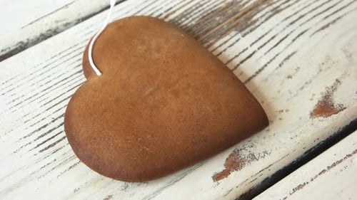 Decorating Heart Shaped Gingerbread Cookie with White Icing