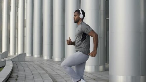 Athletic Man Running in Place in Slow-Motion, Exercising and Lifting Legs