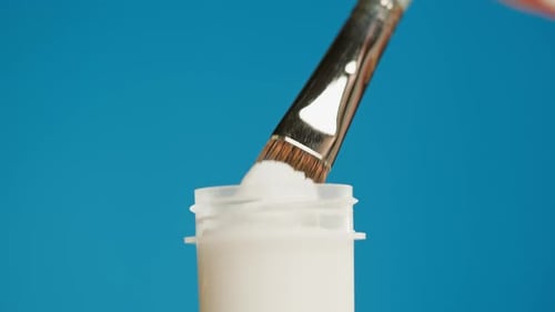 White Paint Isolated on Blue Background