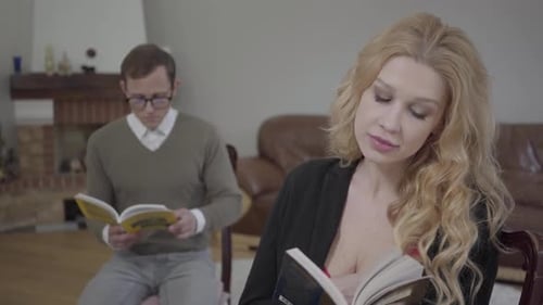 Woman and Man Reading Books Inside Living Room