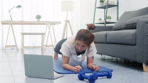 Woman Doing Plank Exercise at Home