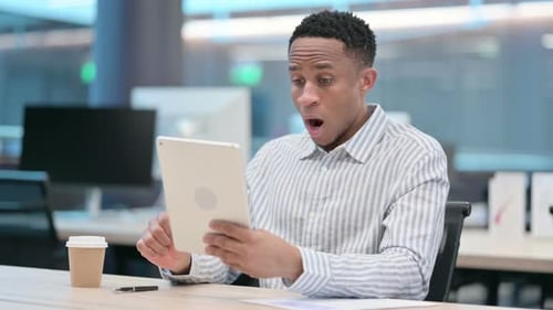 Man Shocked by Something He Sees on Tablet
