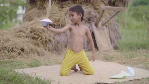 Happy Child Holding Paper Airplane Outside
