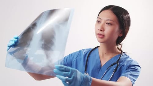 Young Doctor Reviews Patient X-Ray in Hospital