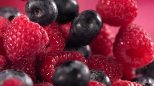 Slow Motion Dropping Blueberries and Raspberries Close Up