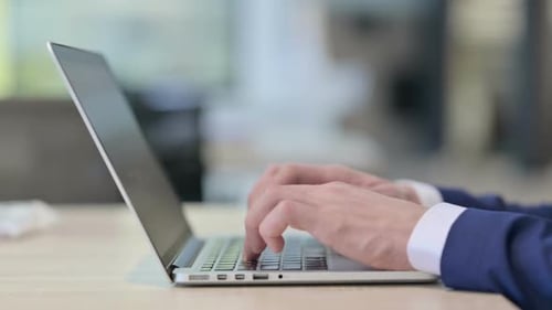 Close Up of Hands Typing on Laptop