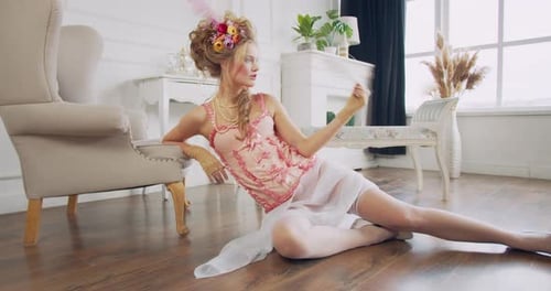 Woman in Historical Corset and Hairstyle Posing Indoors