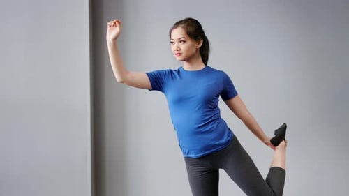 Young Woman Poses in Yoga Position Indoors