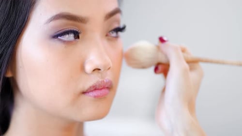 Closeup Face of Young Attractive Korean Model at Studio While Professional Makeup Artist Working