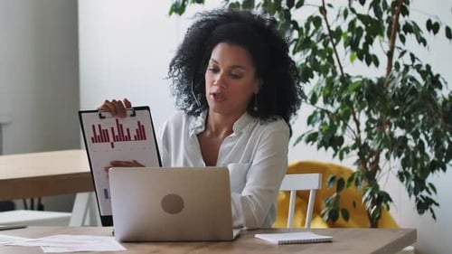 Woman Presents Data at Virtual Business Meeting