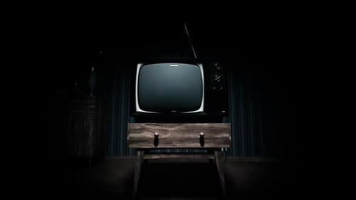 Old-fashioned vintage tv with antenna on the tv stand in the retro apartment.