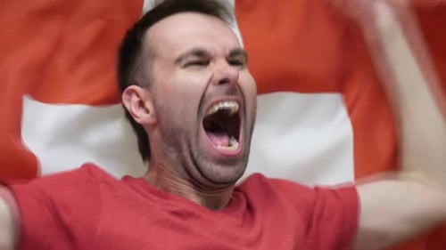 Man Yelling and Celebrating with Flag