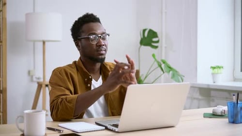 African Man Resting After Working at Computer in Home Office Spbas