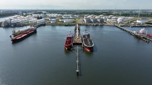 Crude Oil Tanker Ships Unloading Petrochemicals to a Shore Fuel Depot
