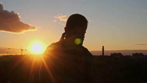 Man Puts on Sunglasses at Colorful Sunset