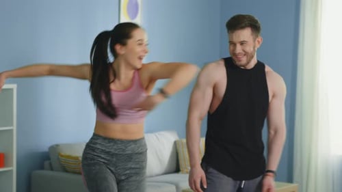 Couple Working Out and Exercising Together at Home