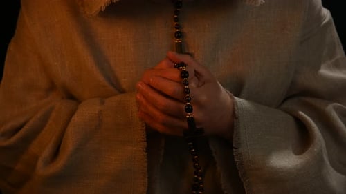 Hands Holding Rosary Beads for Prayer