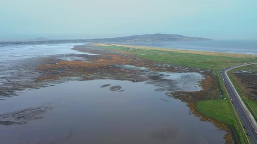 Cars Driving Along Scenic Coast Line Aerial Footage