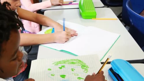 Children Drawing with Pencils in Classroom Setting