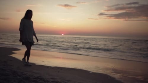 Silhouette of Skinny Longhaired Girl Walking Along Empty Beach Touching Long Hair Enjoying Beautiful