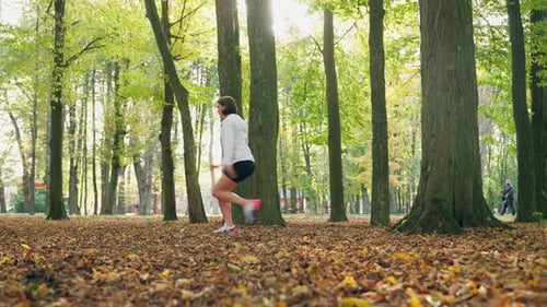 Woman Doing Fitness Exercises at City Park