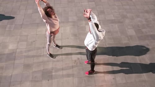 Young Adults Stretching Together in City Square