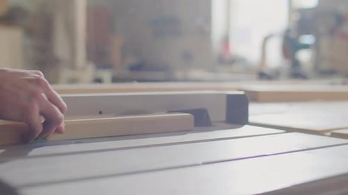 Man Cutting Wood with a Table Saw