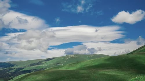 Top View of the Beautiful Wide Hills of the Mountain, Covered with Grass Under Layers of Cirrus