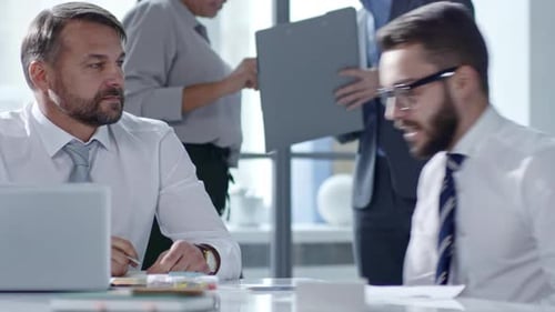 Men Shaking Hands and Talking in Office