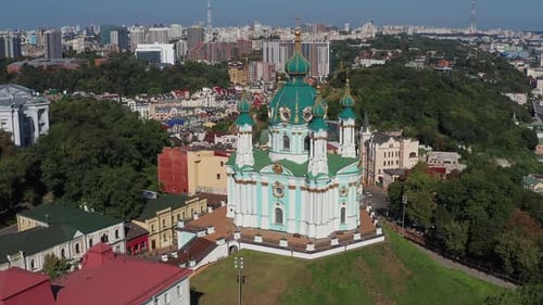 Beautiful flight over St. Andrew's Church in Kiev. Top view of Podol. Many buildings and churches.
