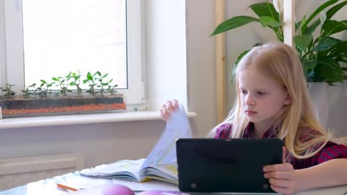 Girl Studies with Tablet and Textbook at Home