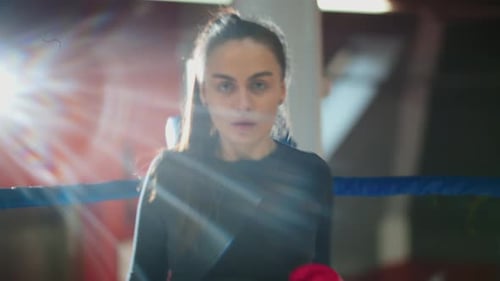 Female Boxer Practicing Punches in the Ring