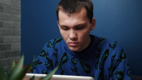 Young Adult Using a Tablet Indoors