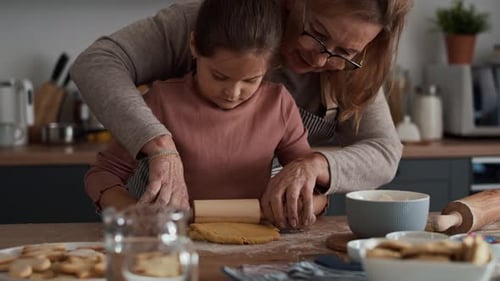 Senior Woman and Child Baking Cookies Together at Home
