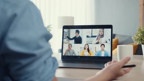 Asia businessman using laptop talk to colleagues about plan in video call meeting while work.