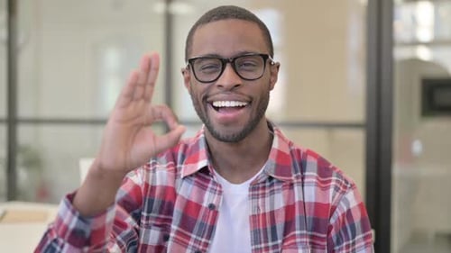 Cheerful Young Adult Giving 'Ok' Hand Gesture