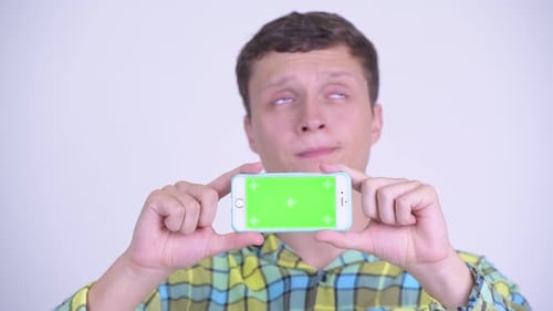 Young Adult Holding Phone with Green Screen