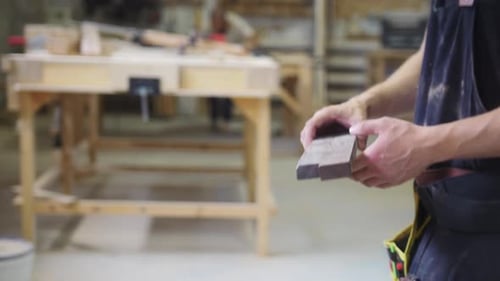 Carpentry Workshop Man Worker Cutting a Wooden Plank with a Big Circular Saw