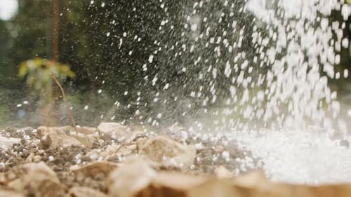 Slow motion of white fertilizer being poured into soil