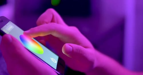 Adult Adjusting Colors on Mobile Phone Application