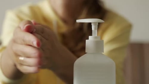 Close Up Woman Hands is Spraying Sanitizer or Alcohol Gel on Her Hands